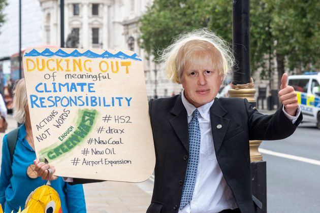 Extinction Rebellion protesters with a Boris Johnson mask