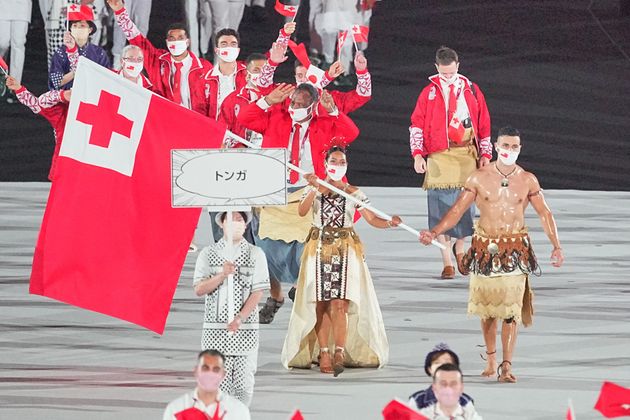 23 July 2021, Japan, Tokio: Olympics: Opening Ceremony at Olympic Stadium. Tonga flag bearers Malia Paseka and taekwondo fighter Pita Taufatofua lead the team into the Olympic Stadium at the opening ceremony of the 2020 Olympics. Photo: Michael Kappeler/dpa (Photo by Michael Kappeler/picture alliance via Getty Images)