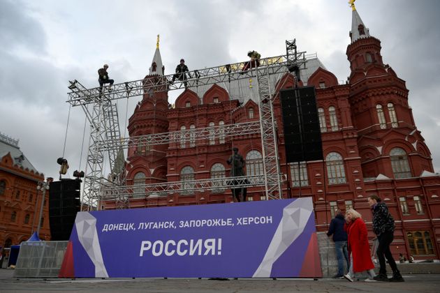 Workers fix a banner reading 