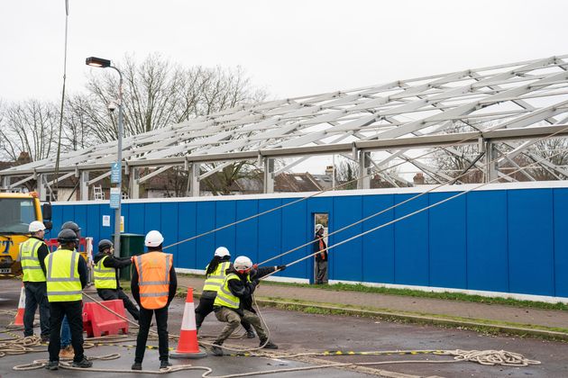 Construction workers at work building a Nightingale 'surge hub' at St George's Hospital, in south west London