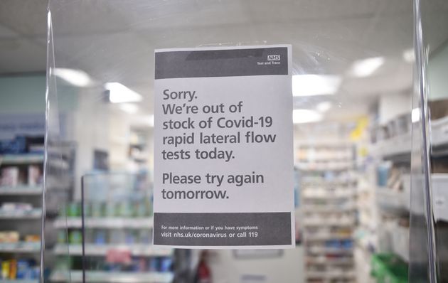 <strong>A sign in a chemist's shop displays they are out of stock of government-provided Covid-19 lateral flow tests in Cheadle, England.</strong>