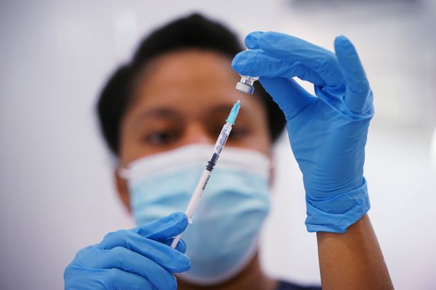 <strong>A nurse prepares a dose of the Pfizer Covid-19 jab at a vaccination site in Liberty Shopping Centre, Romford, east London.</strong>