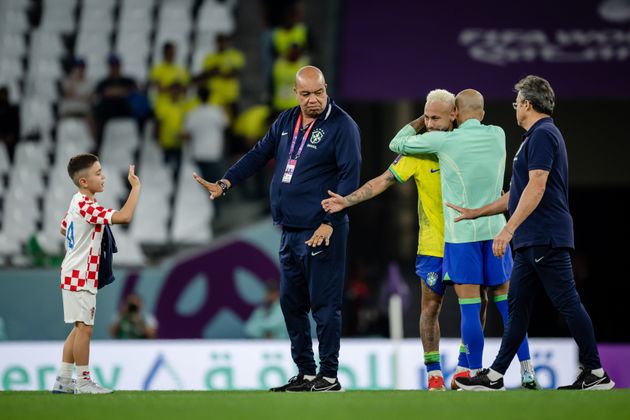 Neymar looks dejected and shake hands with the young son of Croatian player Ivan Perisic.