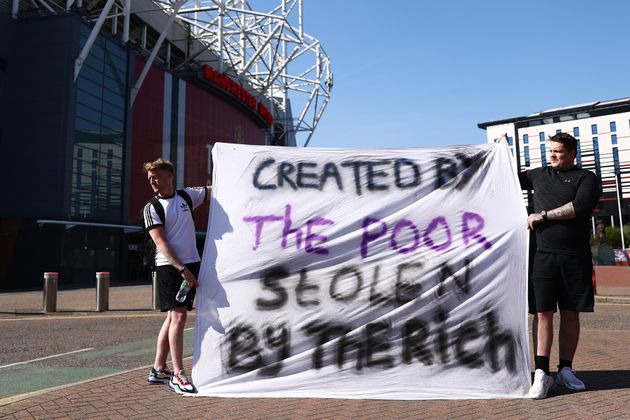 <strong>Football fans opposing the European Super League outside Old Trafford in Manchester.</strong>