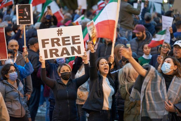 People demonstrate against the Iranian regime during a protest at Mel Lastman Square in Toronto, Sept. 24.