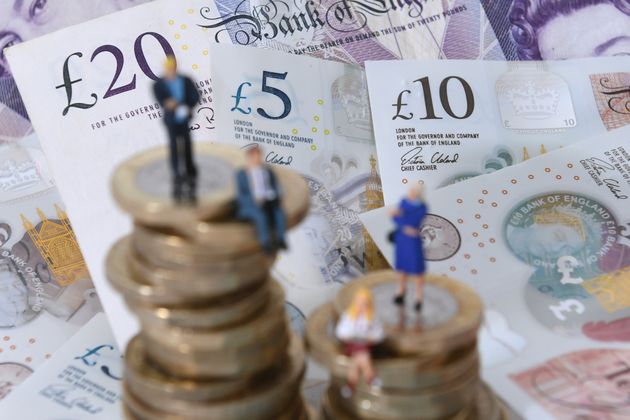 File photo dated 12/09/18 of models of men and women on a pile of coins and bank notes, as fraud and error levels in benefits spending are unacceptably high, according to a watchdog, which said more must be done to get a grip on the billions of pounds being lost every year.