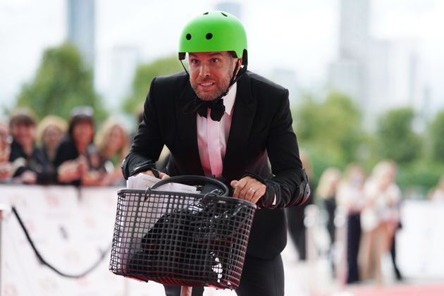 The face of a man desperate not to fall off a scooter in front of the entire nation's press