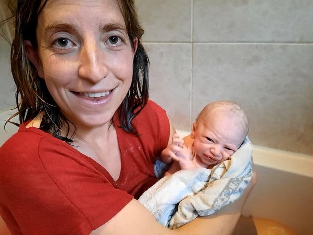 Corinne Card with her baby Freddie, shortly after giving birth in the bath.