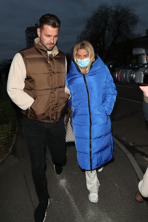 Katie leaving court with her fiancé Carl Woods last month