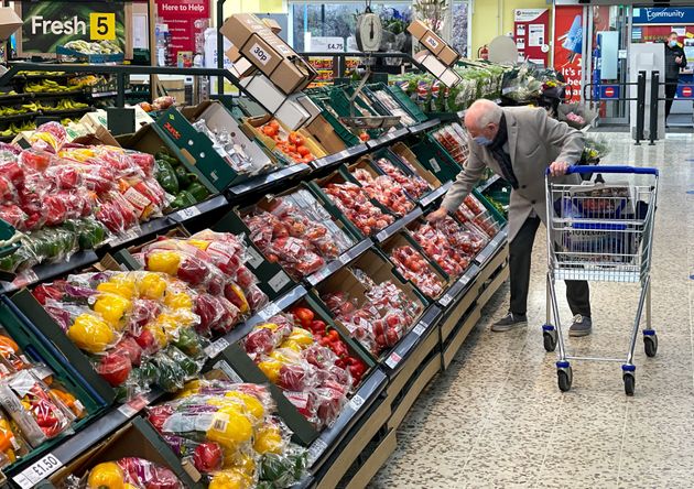 A customer shops for food items inside a Tesco supermarket store in east London.