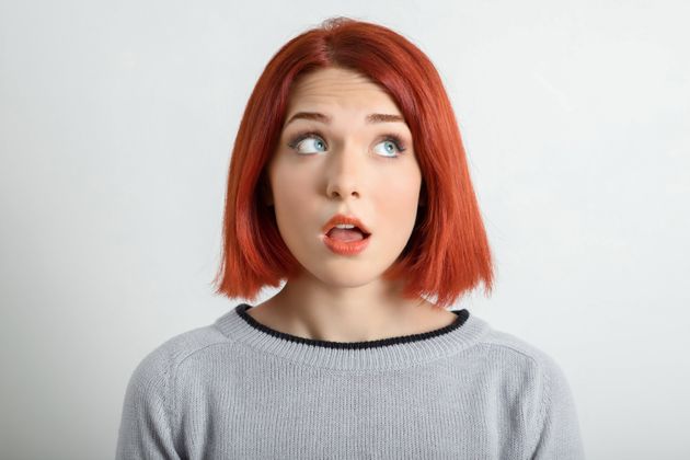 Young woman looking away with thoughtful facial expression