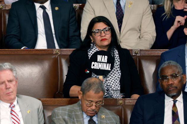 Rep. Rashida Tlaib holds a sign that reads 