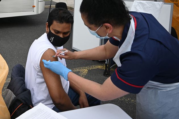 <strong>A member of the public receives a Covid-19 vaccine at a temporary vaccination centre at the Essa academy in Bolton.</strong>