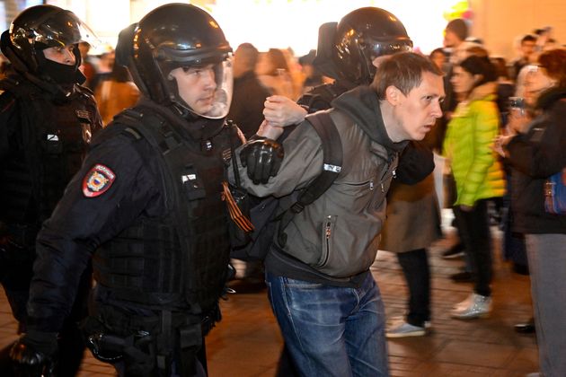 Police officers detain a man in Moscow on September 21, 2022, following calls to protest against partial mobilisation announced by President Vladimir Putin. - President Vladimir Putin called up Russian military reservists on September 21, saying his promise to use all military means in Ukraine was 