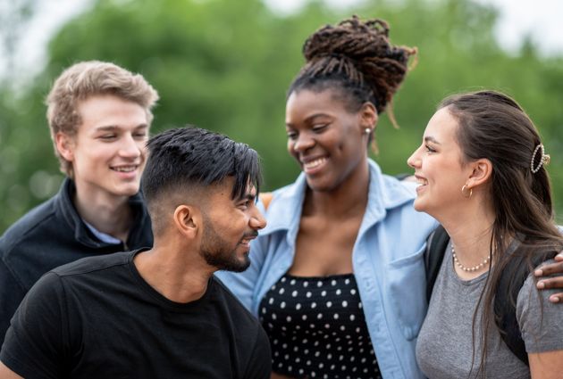 A diverse group of undergrads gather outside.