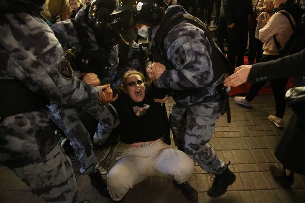 Russian police officers detain a protester during a protest rally at Arbat street in Moscow, Russia.