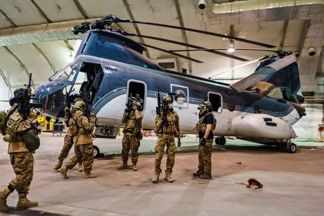 Taliban fighters from the Fateh Zwak unit, wielding American supplied weapons, equipment and uniforms, storm into the Kabul International Airport, Tuesday, Aug. 31, 2021. 