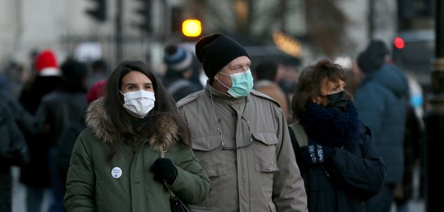 People wearing masks around London shortly after the Omicron variant was found in the capital