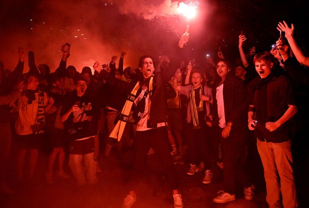 Australian fans celebrate in Melbourne after Australia's victory over Denmark in their Qatar 2022 World Cup Group D football match.