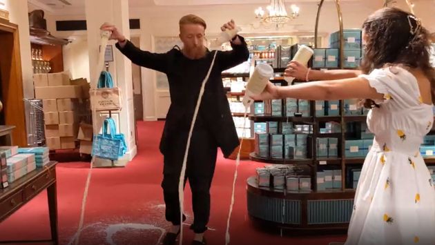 Grab from video issued by Animal Rebellion of supporters of Animal Rebellion pouring out milk in Fortnum & Mason in London.