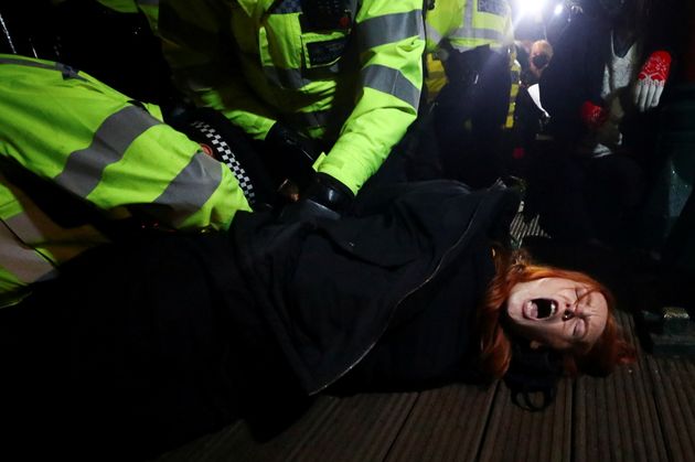 <strong>Police detain Patsy Stevenson as people gather at a memorial site in Clapham Common Bandstand following the murder of Sarah Everard.</strong>