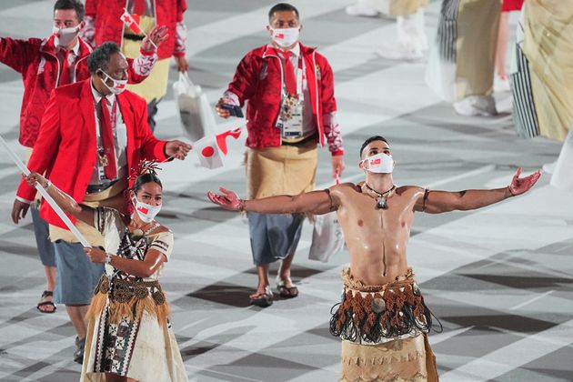 23 July 2021, Japan, Tokio: Olympics: Opening Ceremony at Olympic Stadium. Tonga flag bearers Malia Paseka and taekwondo fighter Pita Taufatofua lead the team into the Olympic Stadium at the opening ceremony of the 2020 Olympics. Photo: Michael Kappeler/dpa (Photo by Michael Kappeler/picture alliance via Getty Images)