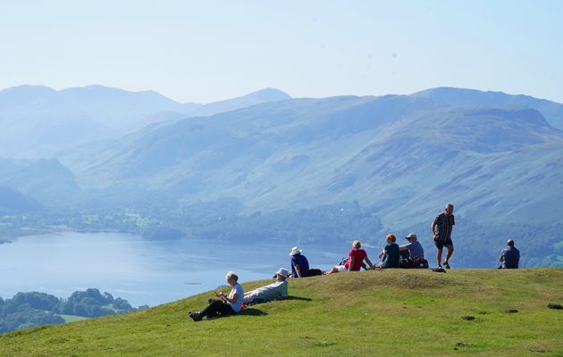 Walkers take in the view of Derwent Water in Cumbria. 