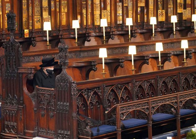 The Queen sits alone in St George's Chapel during the funeral of Prince Philip at Windsor Castle on April 17, 2021.