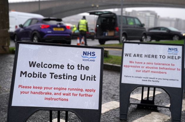 <strong>Signs at a mobile Covid-19 test site in Glasgow, Scotland, where people have been asked to reduce their social contact as much as possible by meeting in groups of no more than three households.</strong>