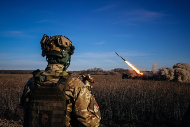 TOPSHOT - A Ukrainian soldier watches a self-propelled 220 mm multiple rocket launcher 