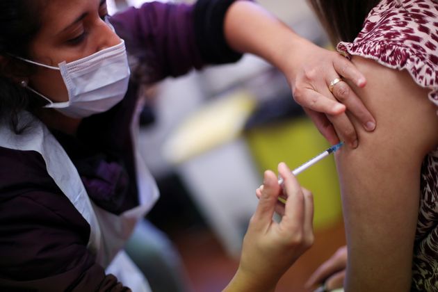 <strong>A health worker administers a dose of the Covid-19 booster vaccine in Derby.</strong>