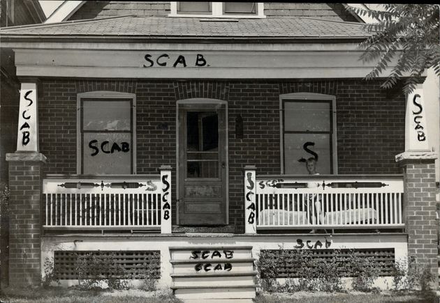 A strikebreaker's house in Canada is shown smeared with the painted word scab in 1946.