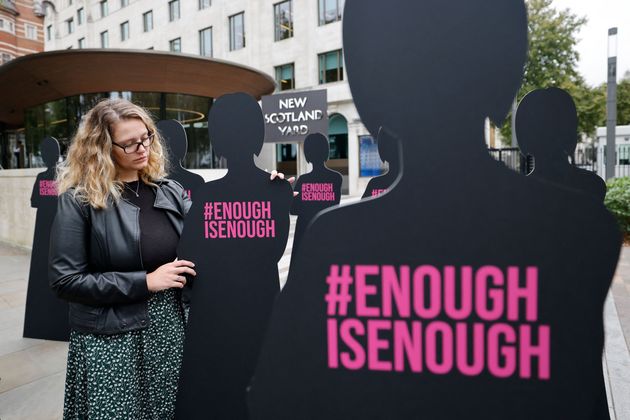 <strong>A campaigner poses with cut-out silhouettes outside the Metropolitan Police headquarters.</strong>