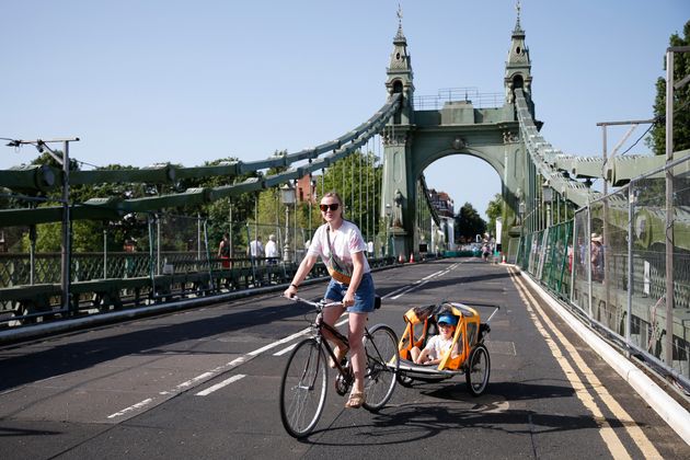 A cyclist rides over Hammersmith Bridge on July 17. The bridge was closed last year after cracks in the bridge worsened during a heatwave