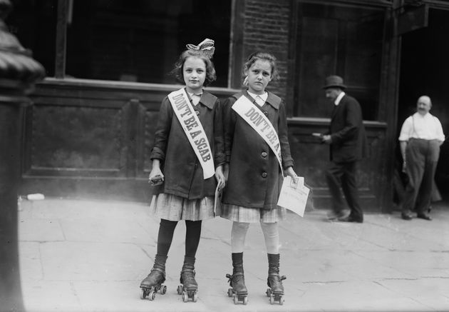 Two young strike sympathisers on roller skates in the U.S. circa 1910s.