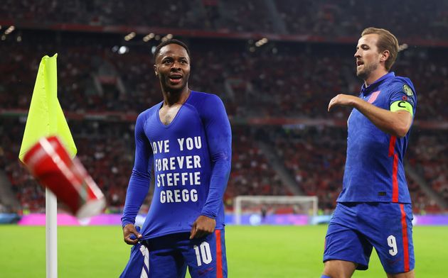 <strong>Raheem Sterling celebrates with Harry Kane after scoring their team's first goal wearing a T-shirt that reads 