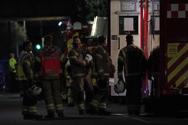 Firefighters at the scene in Sutton, south London, where four children have died following a fire at a house.