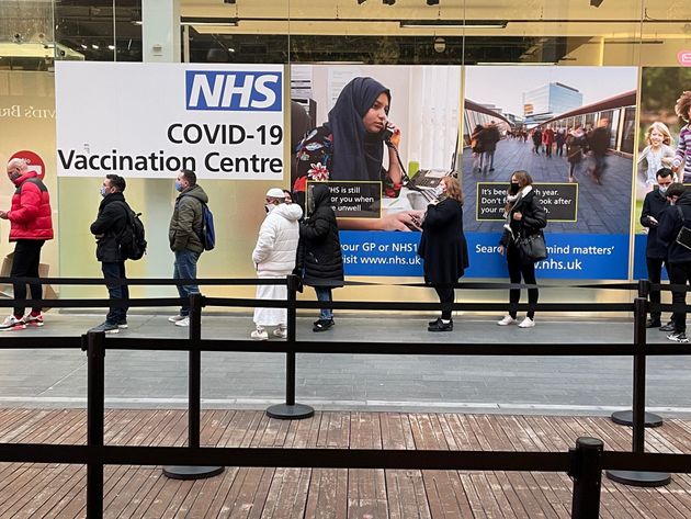 <strong>People queue at a Covid Vaccination Centre at the Westfield shopping centre in Stratford, east London.</strong>