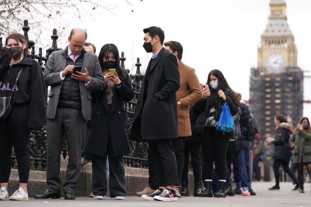 <strong>People queuing on Westminster Bridge for booster jabs at St Thomas' Hospital, London.</strong>