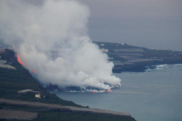 Lava flows into the sea, as seen from Tijarafe, following the eruption of a volcano on the Canary Island of La Palma, Spain