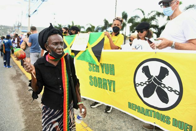 People calling for slavery reparations protest outside the entrance of the British High Commission during William and Kate's visit to Kingston, Jamaica, on March 22.