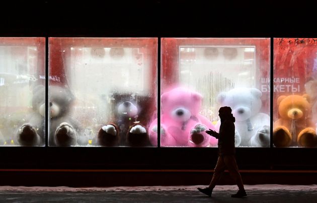 A pedestrian walks past a shop window with teddy bears as decoration ahead of the Christmas festivities in Moscow on Monday. 