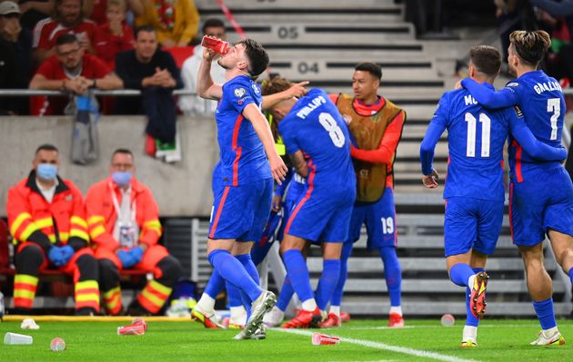 <strong>Declan Rice drinks from a cup that was thrown at Raheem Sterling after scoring their first goal.</strong>