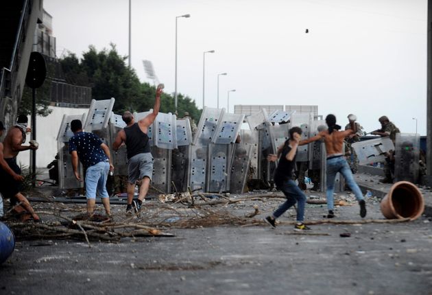 Protestors throw stones at Lebanese army members in Beirut in July this year as demonstrations continue