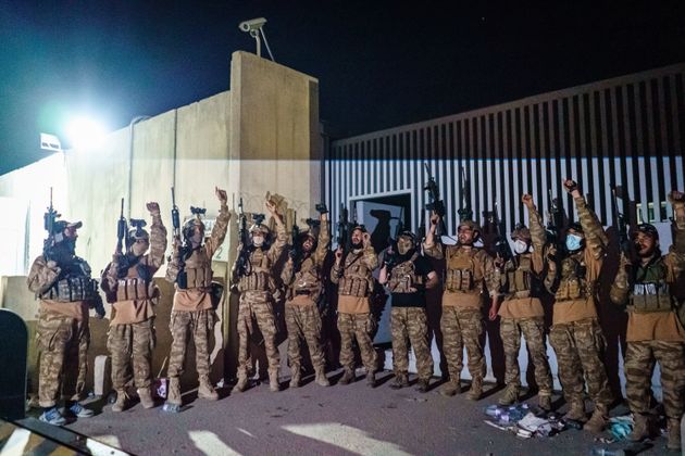 <strong>Taliban fighters from the Fateh Zwak unit celebrate before storming into the Kabul International Airport, wielding American supplied weapons, equipment and uniforms after the United States Military have completed their withdrawal, in Kabul, Afghanistan.</strong>