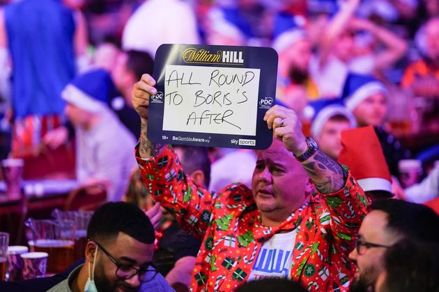 <strong>Fan holding a sign mentioning Boris Johnson during the World Darts Championship at Alexandra Palace, London on Monday.</strong>