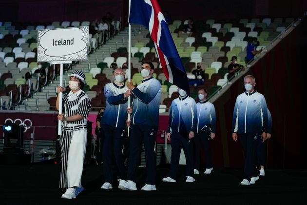 Snaefridur Sol Jorunnardottir and Anton Mckee, of Iceland, carry their country's flag during the opening ceremony.