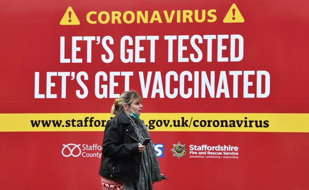 <strong> A woman walks past a coronavirus test centre in Newcastle-Under-Lyme.</strong>