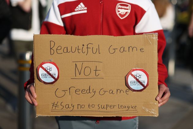 <strong>Fans display banners at The Emirates opposing Arsenal signing up for the newly proposed Super League.</strong>