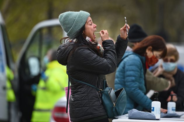 <strong>People take part in coronavirus surge testing on Clapham Common, south London.</strong>